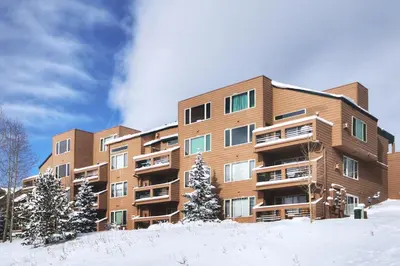 an apartment building in the snow in the winter at 522 Watch Hill Condo in Silverthorne
