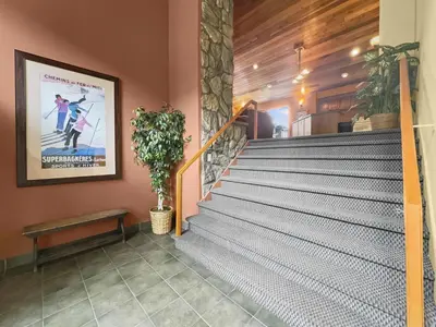 a staircase in a building with a poster on the wall at A308 Lake Cliffe Condo in Dillon