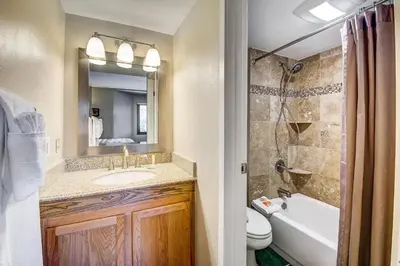 a bathroom with a sink and a toilet and a shower at 1088 Wild Irishman Condo in Keystone