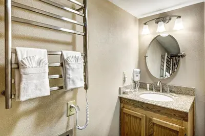 a bathroom with a sink and a mirror at 1088 Wild Irishman Condo in Keystone