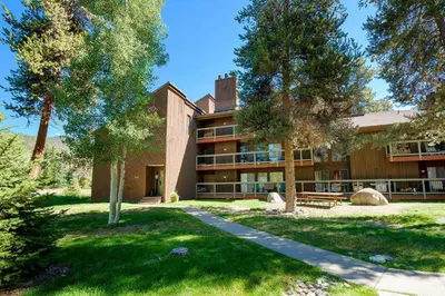 an exterior view of a building with trees at 1088 Wild Irishman Condo in Keystone