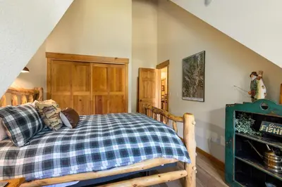 a bedroom with a bed and a fireplace at 2674 Tenderfoot Lodge Condo in Keystone