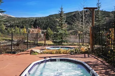 a hot tub in a yard with a fence at 2674 Tenderfoot Lodge Condo in Keystone