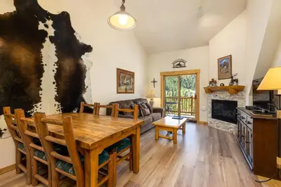 a living room with a table and a couch at 2674 Tenderfoot Lodge Condo in Keystone