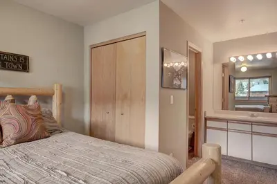 a bedroom with a bed and a bathroom at C213 Cinnamon Ridge Condo in Keystone