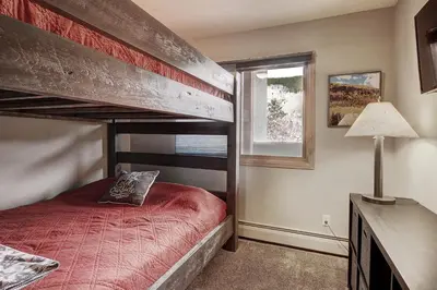 a bedroom with a bunk bed and a window at C213 Cinnamon Ridge Condo in Keystone