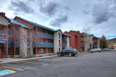 a car parked in a parking lot in front of a building at C213 Cinnamon Ridge Condo in Keystone
