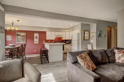 a living room with a couch and a kitchen at C213 Cinnamon Ridge Condo in Keystone