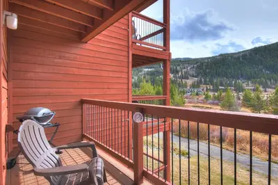 a helmet sitting on a chair on the balcony of a cabin at C213 Cinnamon Ridge Condo in Keystone