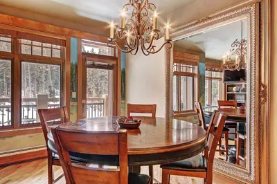 a dining room with a table and chairs and a chandelier at 3044 Lone Eagle Condo in Keystone