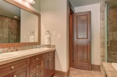 a bathroom with a sink and a shower and a mirror at 3044 Lone Eagle Condo in Keystone