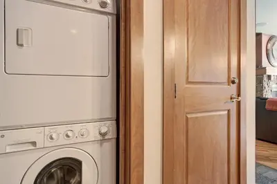 a laundry room with a washer and dryer next to a door at 3044 Lone Eagle Condo in Keystone