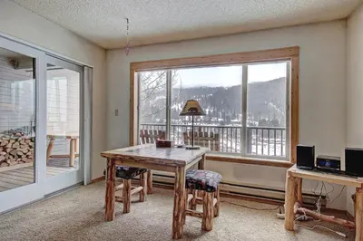 a dining room with a table and a large window at Cri221 Cinnamon Ridge Condo in Keystone
