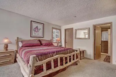 a bedroom with a large wooden bed in a room at Cri221 Cinnamon Ridge Condo in Keystone