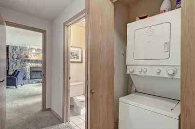 a laundry room with a washer and dryer and a bathroom at Cri221 Cinnamon Ridge Condo in Keystone