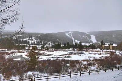 a snow covered valley with a town and a mountain at Cri221 Cinnamon Ridge Condo in Keystone