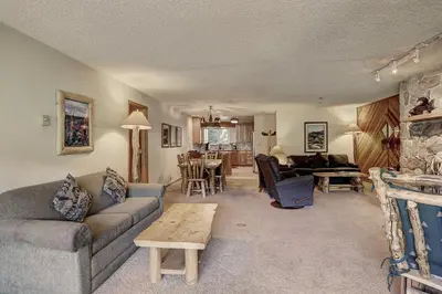 a living room with a couch and a table at Cri221 Cinnamon Ridge Condo in Keystone