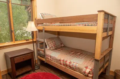 a bedroom with two bunk beds and a lamp at 6506 Settlers Creek Condo in Keystone