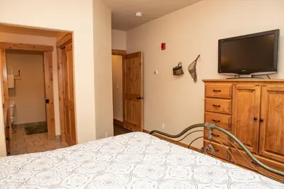 a bedroom with a bed and a flat screen tv at 6506 Settlers Creek Condo in Keystone