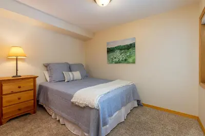 a small bedroom with a bed and a dresser at 130 Meisel Drive Townhouse in Keystone
