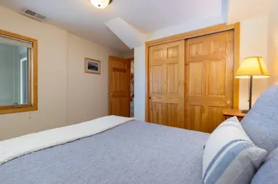 a bedroom with a bed and a wooden door at 130 Meisel Drive Townhouse in Keystone