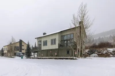 a large house in the snow in front of a field at 130 Meisel Drive Townhouse in Keystone