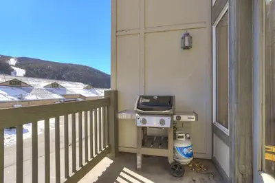 a grill on the balcony of a house at 130 Meisel Drive Townhouse in Keystone