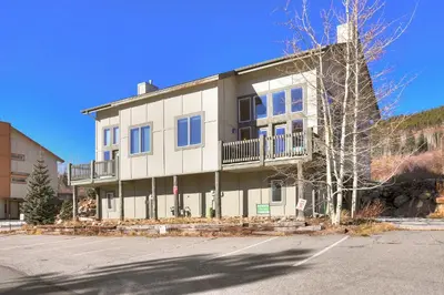a white building with a balcony on the side of it at 130 Meisel Drive Townhouse in Keystone