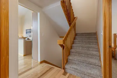 a staircase in a home with wooden floors at 130 Meisel Drive Townhouse in Keystone