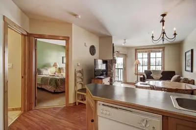 a kitchen and living room with a bed and a sink at 8493 Dakota Lodge Condo in Keystone