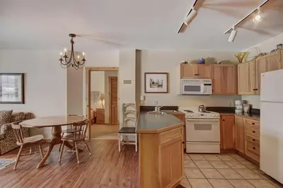 a kitchen and dining room with a table and a counter top at 8493 Dakota Lodge Condo in Keystone