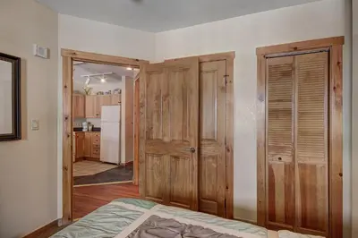 a room with wooden doors and a kitchen at 8493 Dakota Lodge Condo in Keystone