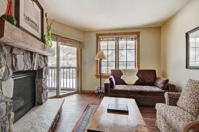 a living room with a couch and a fireplace at 8493 Dakota Lodge Condo in Keystone