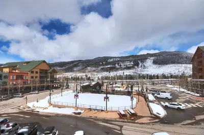 a snow covered parking lot in front of a ski resort at 8493 Dakota Lodge Condo in Keystone
