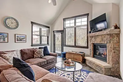 a living room with a couch and a fireplace at 78 Alders Townhouse with Heated Garage in Keystone