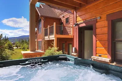 a hot tub in the backyard of a house at 78 Alders Townhouse with Heated Garage in Keystone
