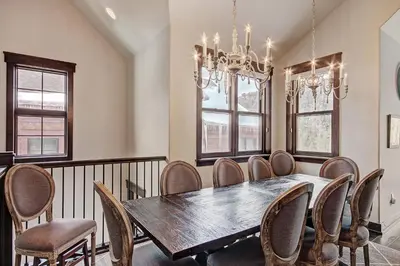 a dining room with a table and chairs and a chandelier at 78 Alders Townhouse with Heated Garage in Keystone