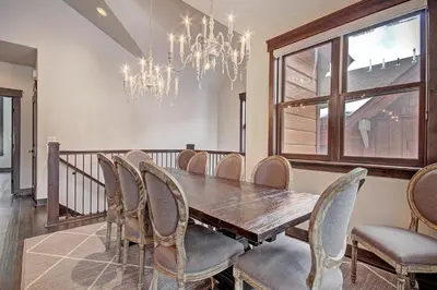 a dining room with a table and chairs and a chandelier at 78 Alders Townhouse with Heated Garage in Keystone