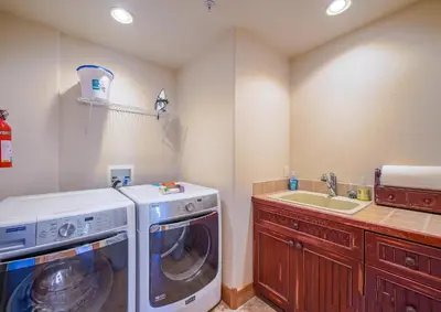 a laundry room with a washer and a sink at 202 Mill Creek Condo in Keystone