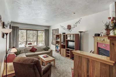 a living room with a couch and a tv at 2062 The Pines Condo in Keystone