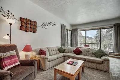 a living room with a couch and a table at 2062 The Pines Condo in Keystone