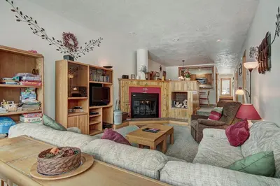 a living room with a couch and a table at 2062 The Pines Condo in Keystone