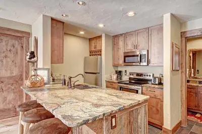 a kitchen with wooden cabinets and a large counter top at 1710 the Willows Condo in Snake River Health Services Incorporated Heliport