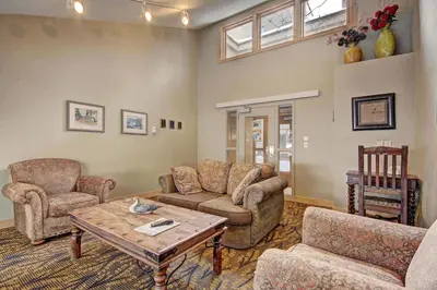 a living room with a couch and chairs and a table at 1710 the Willows Condo in Snake River Health Services Incorporated Heliport