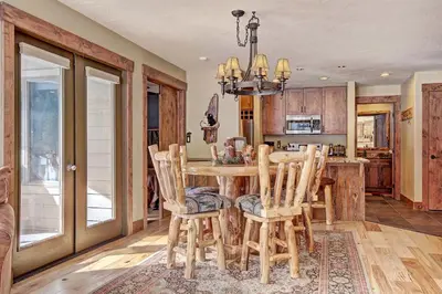 a kitchen and dining room with a wooden table and chairs at 1710 the Willows Condo in Snake River Health Services Incorporated Heliport