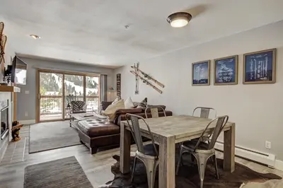 a living room with a table and a couch at C212 Cinnamon Ridge Condo in Keystone