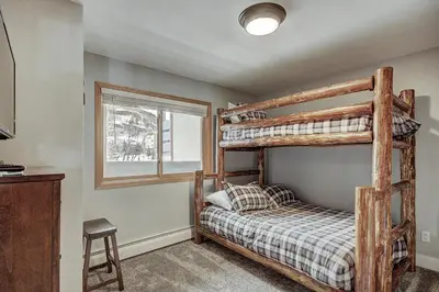 a bedroom with two bunk beds and a window at C212 Cinnamon Ridge Condo in Keystone