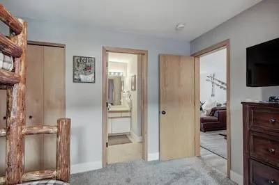 a living room with a sliding door and a television at C212 Cinnamon Ridge Condo in Keystone