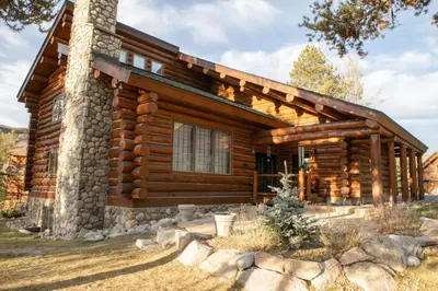 a log cabin with a stone facade at 13 Bear Tree Court Condo in Keystone