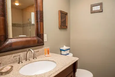 a bathroom with a sink and a toilet and a mirror at 13 Bear Tree Court Condo in Keystone